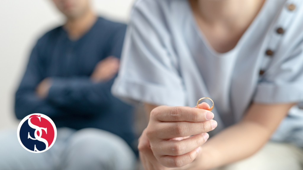 Couple and wife is holding a ring as they discuss divorce. 